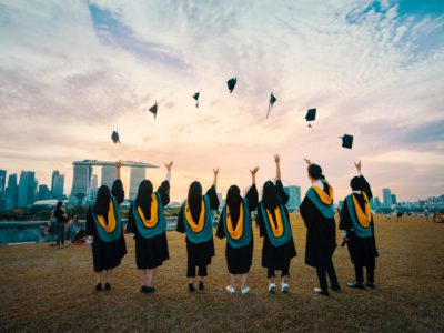 graduates throwing caps