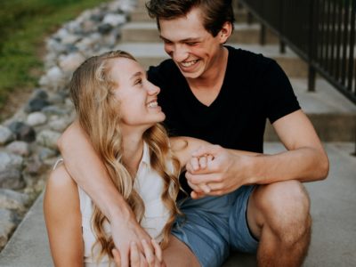 guy with arm around girl smiling