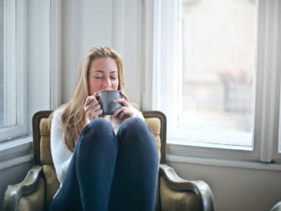 Woman sitting in a chair with a mug